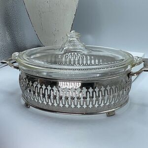 Vintage Pyrex 10” oval Casserole dish lid and ornate metal carrier.